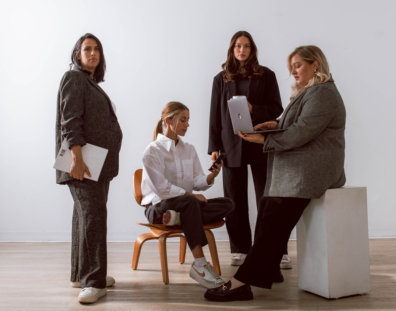 Four professional women on laptops